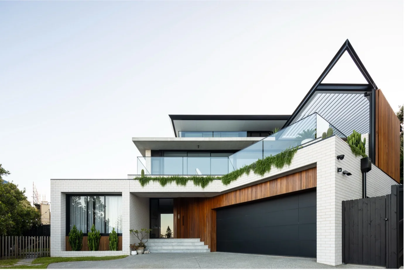 Modern rendered home exterior repainted to withstand coastal sun and salt